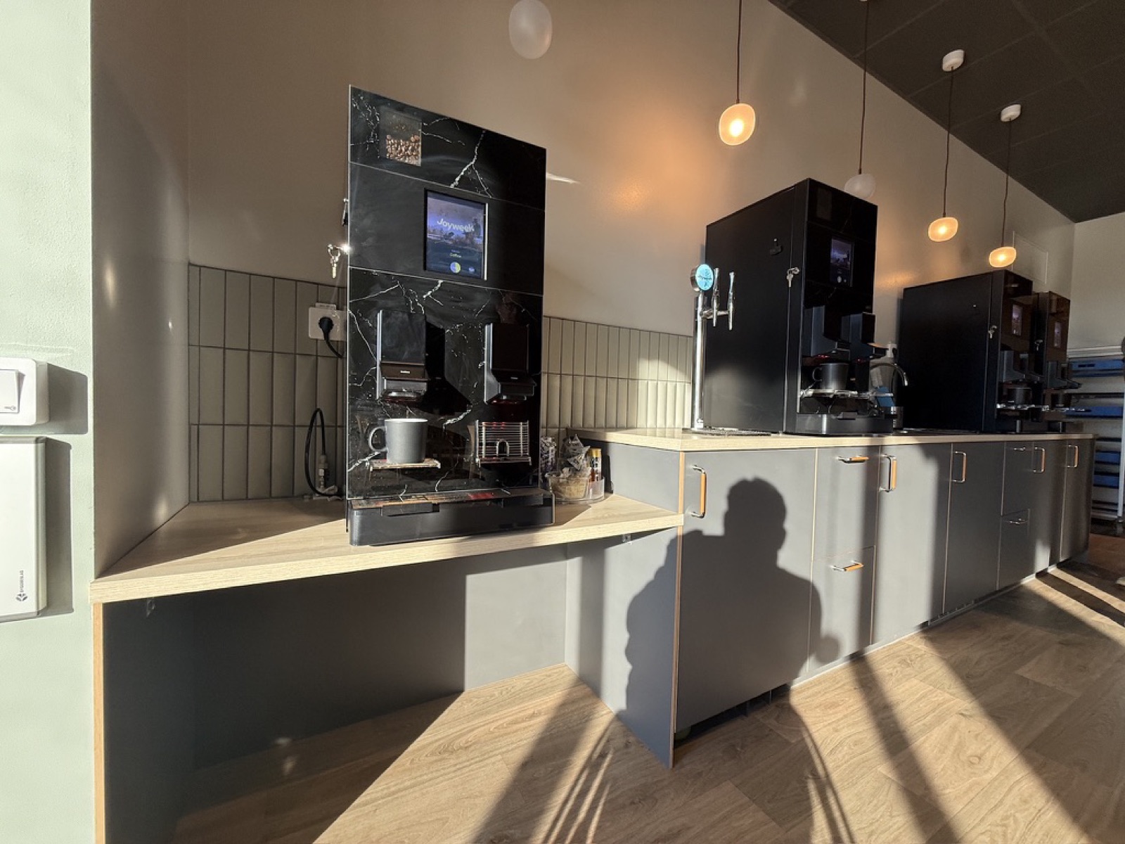 Coffee station with two counter heights, each with its own complete coffee machine
