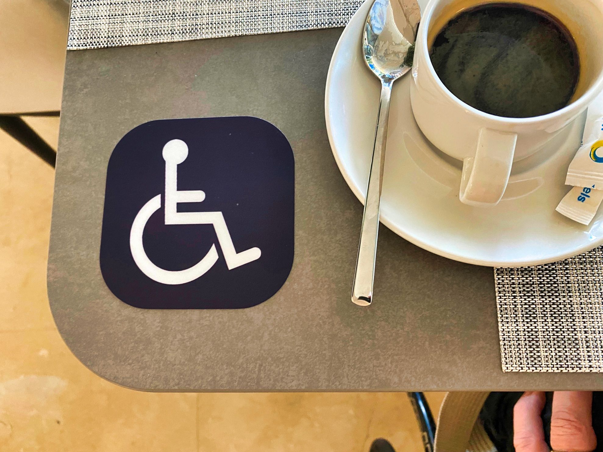 Picture 1. Coffee. And a sign with a person in a wheelchair.